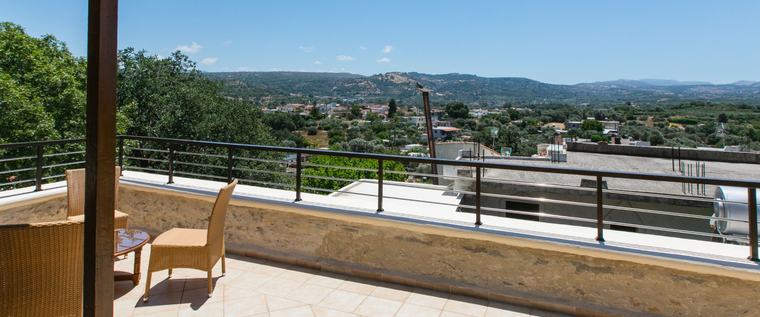 Covered balcony with seating and open views to the hills