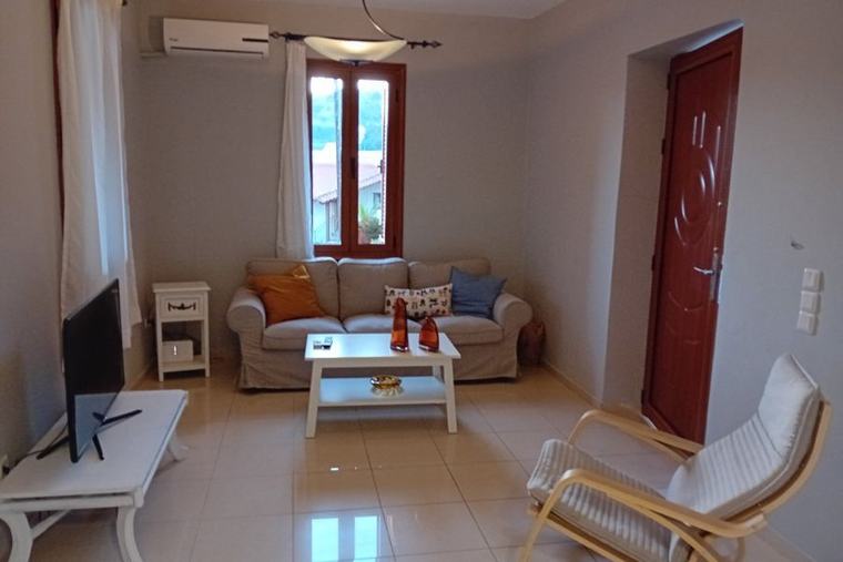 Bright living room with comfortable seating and a village view