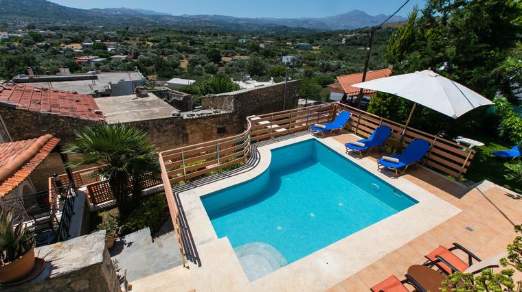 Aerial view of the pool terrace set among the village rooftops