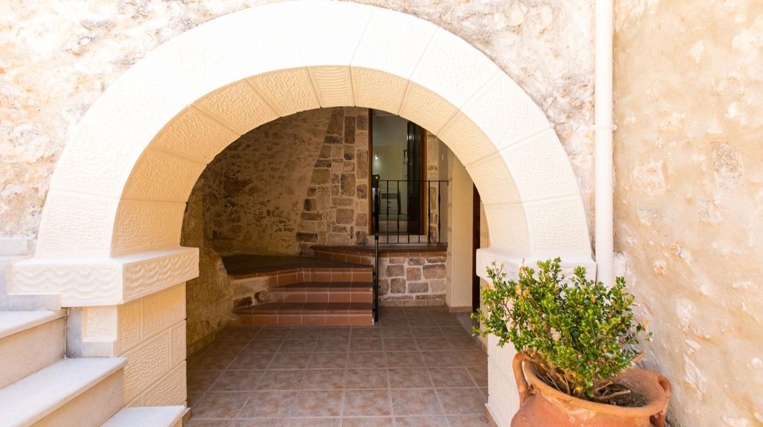 Restored stone archway at the entrance of Bezari Pool Villa in Crete