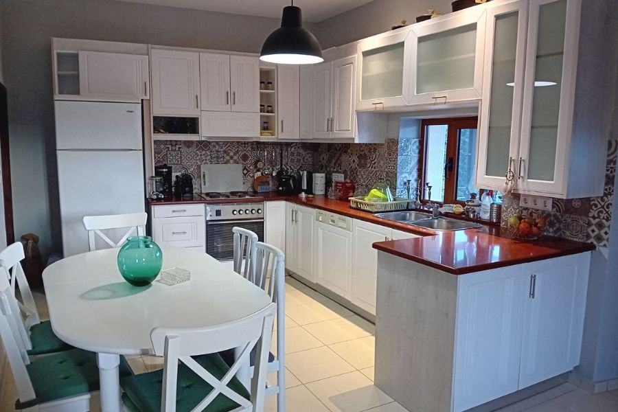 Fully equipped kitchen at Bezari Pool Villa with white cabinetry and traditional tile detailing
